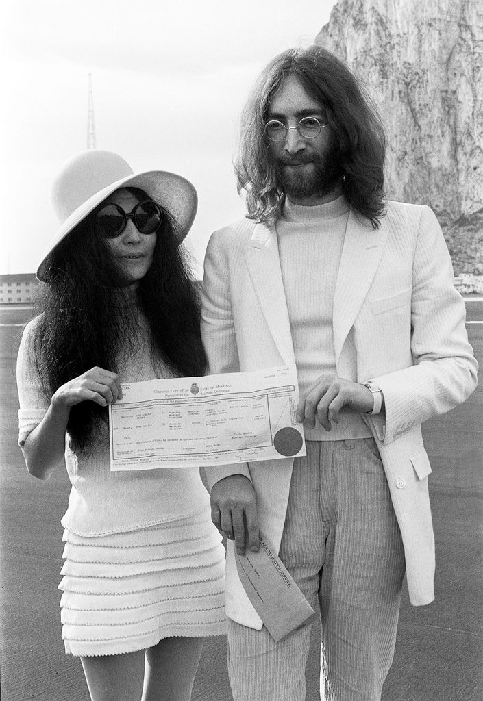 Beatles singer John Lennon and his new bride Yoko Ono holding their marriage certificate after their marriage in Gibraltar. 20 March 1969. (Photo by Daily Herald/Daily Herald/Mirrorpix via Getty Images)