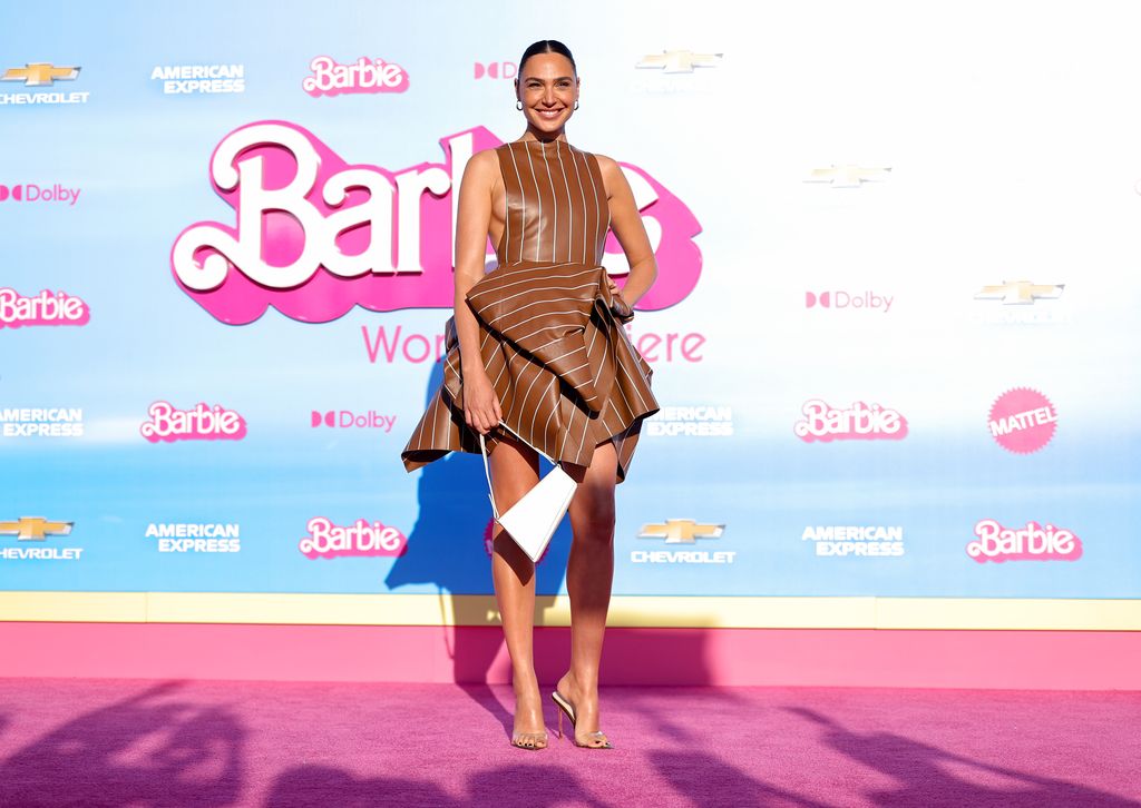 Gal Gadot smiling on the pink carpet at the Barbie premiere