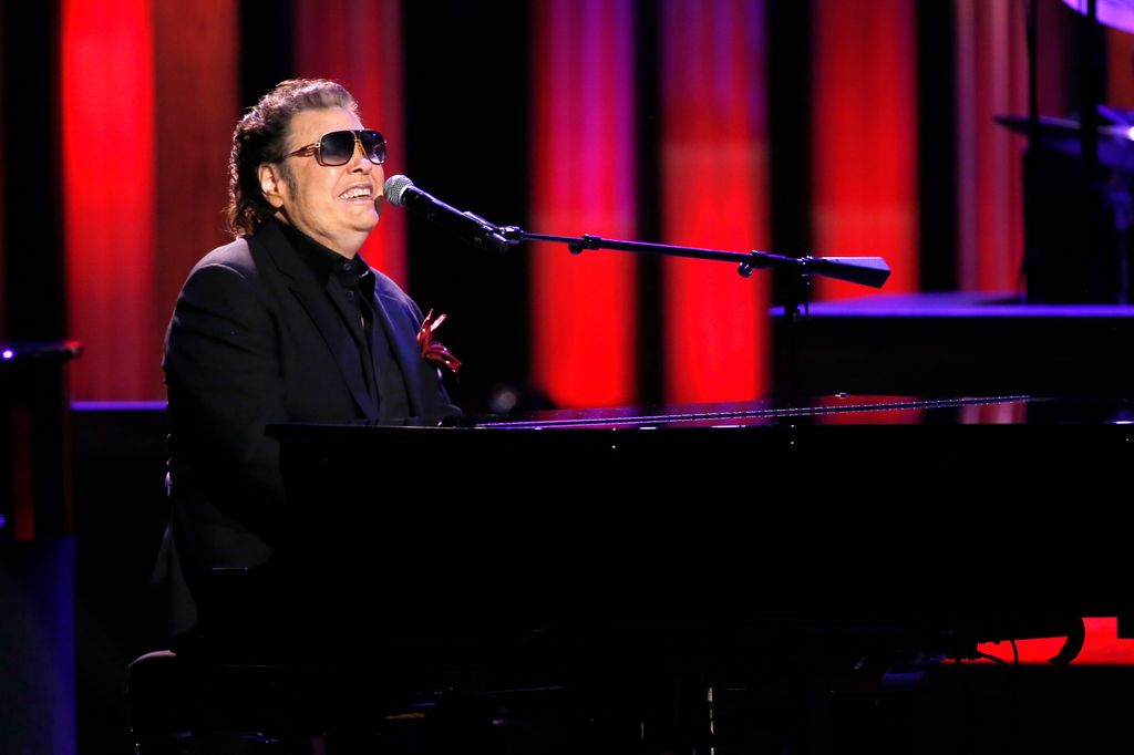 Singer Ronnie Milsap performing on stage at the piano