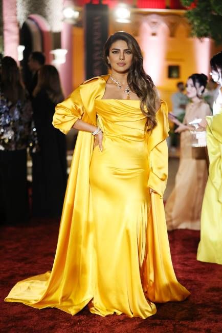 Priyanka Chopra wearing a bright yellow silk dress on the red carpet