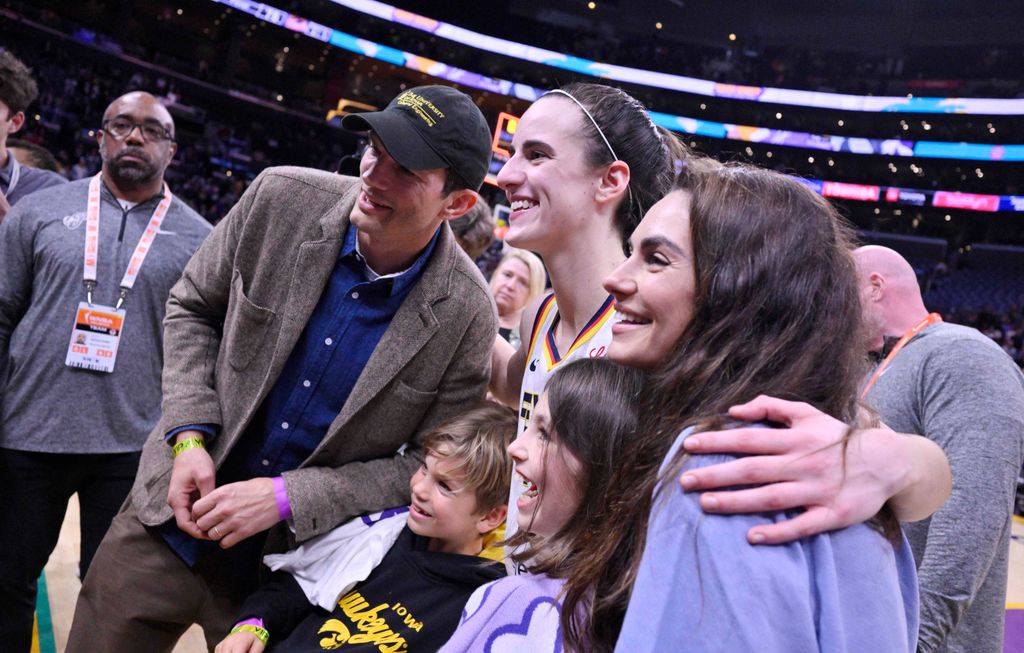 Caitlin Clark of the Indiana Fever poses for pictures with Ashton Kutcher, Mila Kunis and their kids after defeating the Los Angeles Sparks 78-73 to win a WNBA basketball game at Crypto.com Arena in Los Angeles on Friday, May 24, 2024