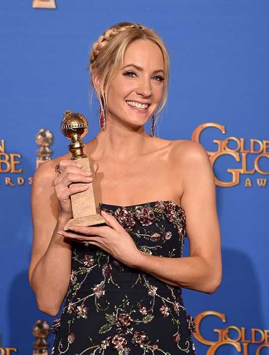 Joanne Froggatt holding her Golden Globe award