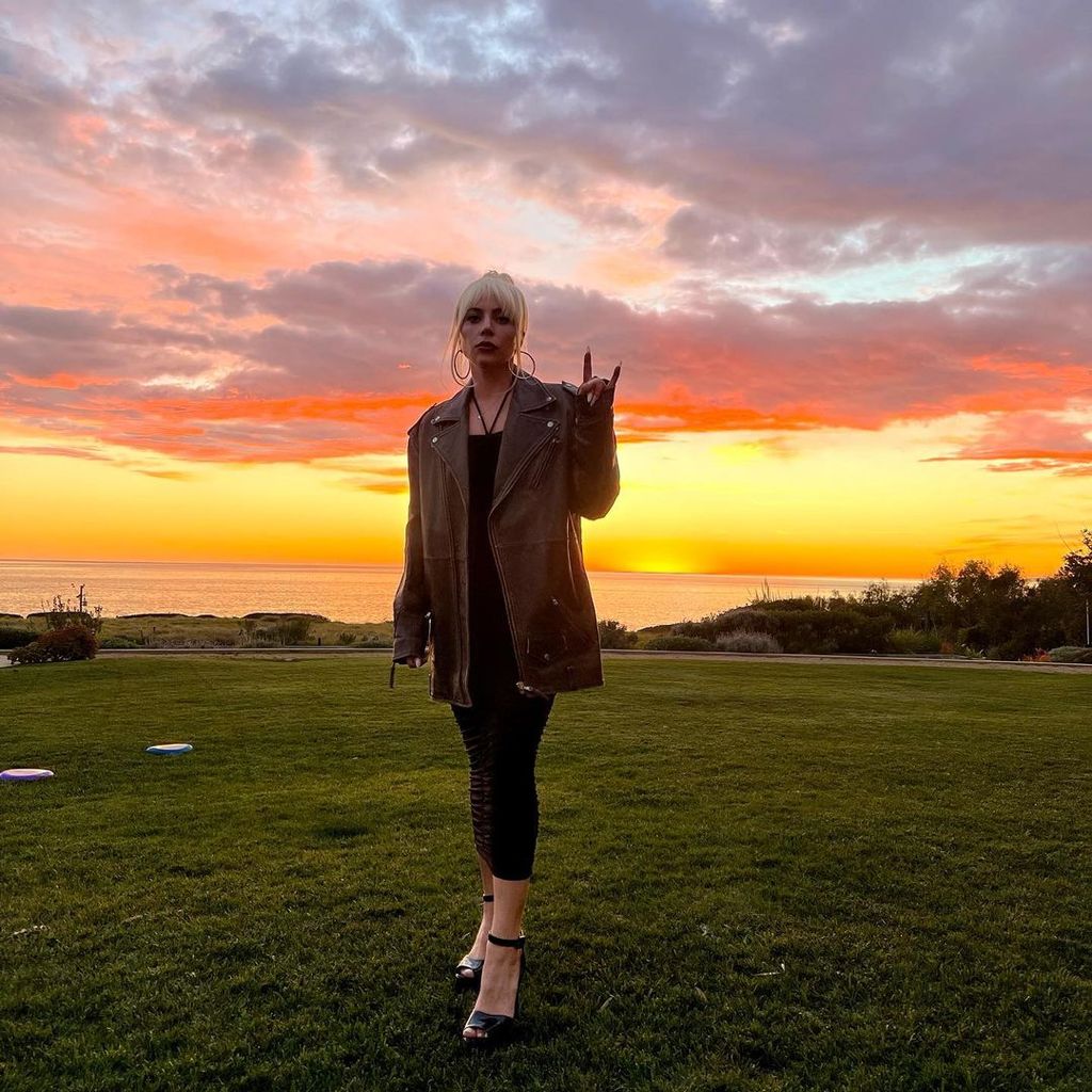 Lady Gaga against the backdrop of the sunset over the ocean