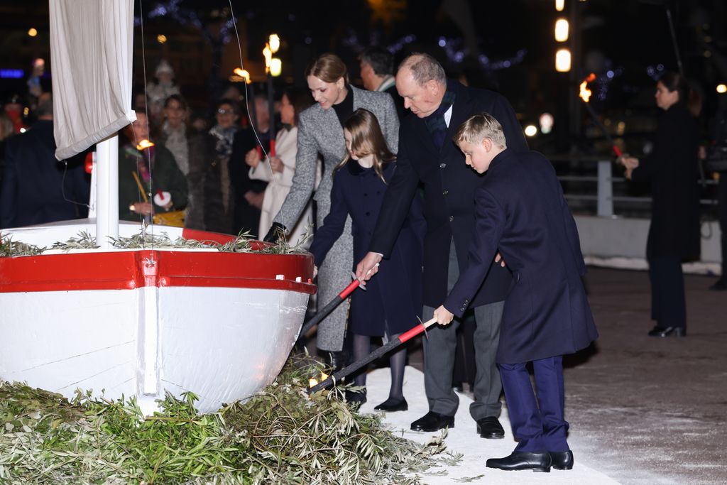 Princess Charlene of Monaco, Princess Gabriella of Monaco, Prince Albert II of Monaco and Prince Jacques of Monaco setting boat on fire
