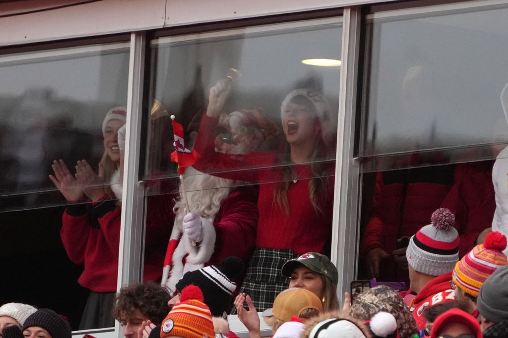 Taylor Swift in a suite ringing a bell during the first half of an NFL football game between the Kansas City Chiefs and the Las Vegas Raiders on December 25, 2023 in Kansas City, Missouri.