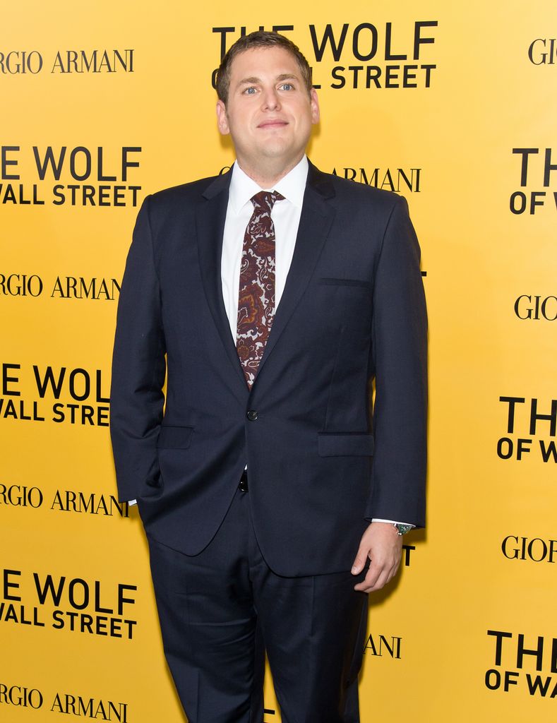jonah hill black suit yellow background
