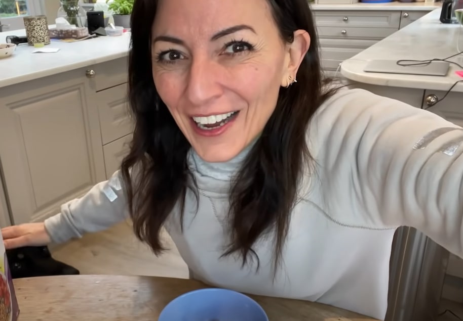 Davina McCall wearing grey jumper at her kitchen table 