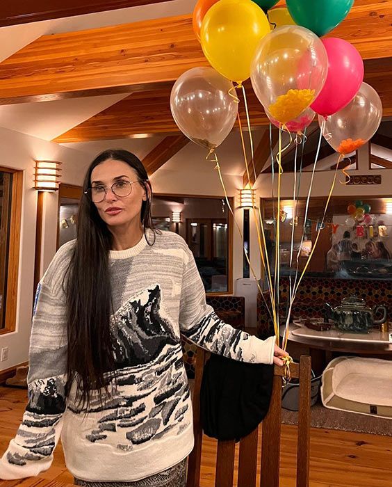 Demi Moore poses with her birthday balloons