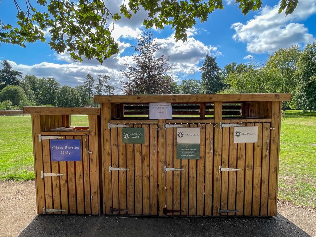 Warning signs against wasps on set of bins