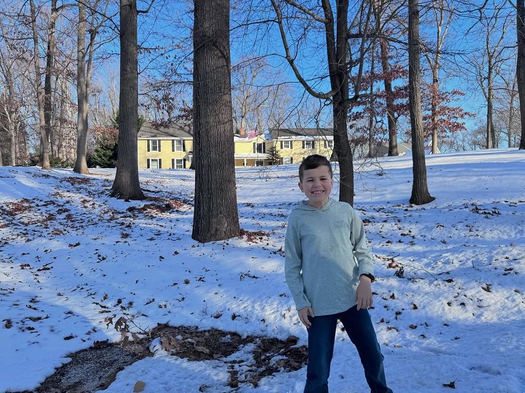 Dylan Dreyer's son poses outside her childhood home which her dad built