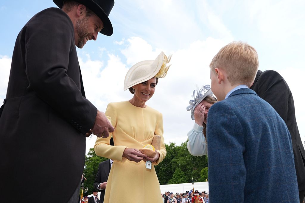 The Prince and Princess of Wales receive Jellycat soft toys and meet the family of Liz Hatton, mother Vicky Robayna, father Aaron and brother Mateo at a Royal Garden Party at Buckingham Palace