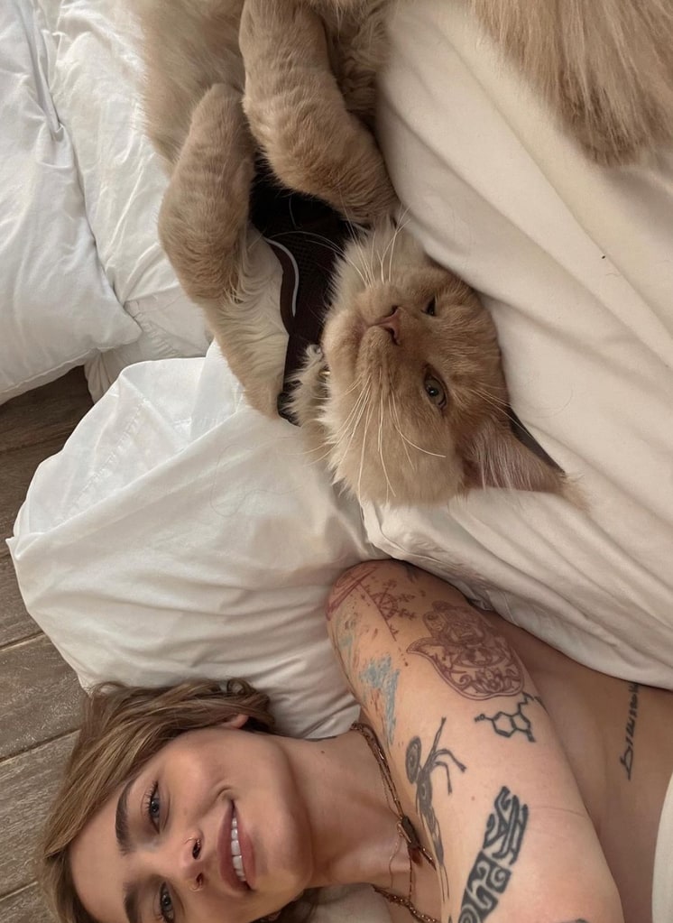 Photo shared by Paris Jackson on Instagram August 2024 lounging with her cat in bed in her Hollywood Hills home