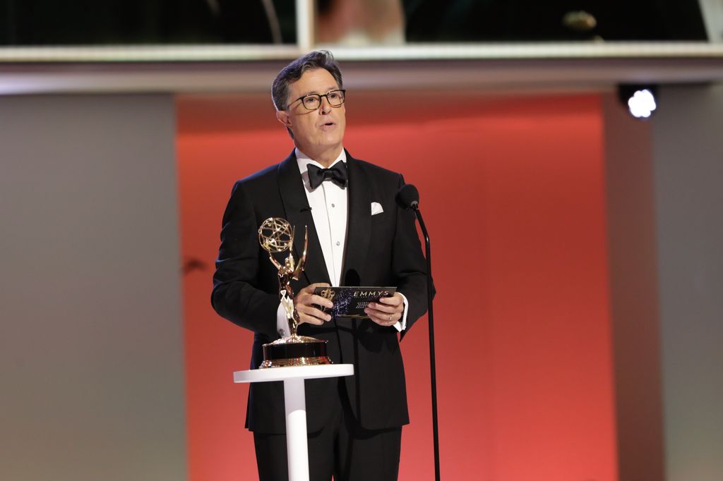 stephen colbert giving speech on stage at emmy awards