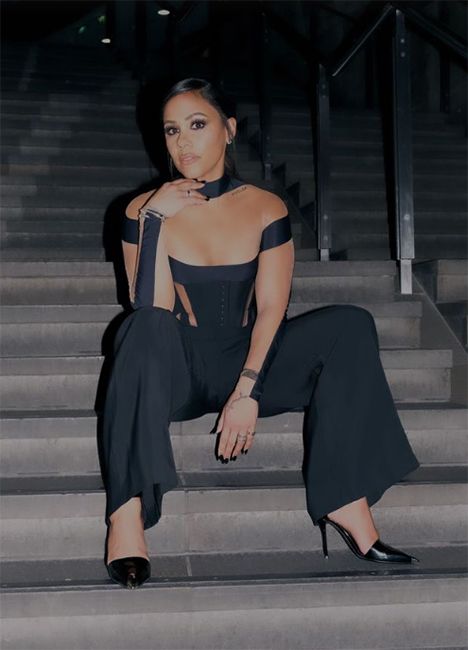 Alex Scott sits on stairs at football awards