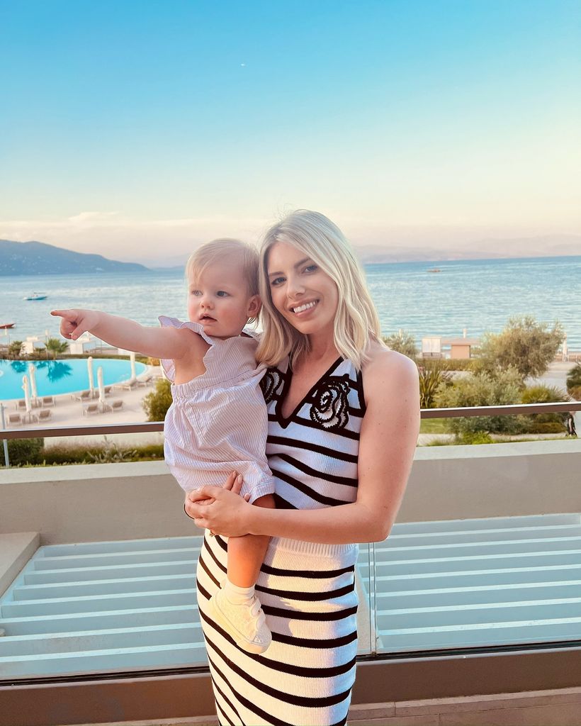 Mollie holding baby in greece