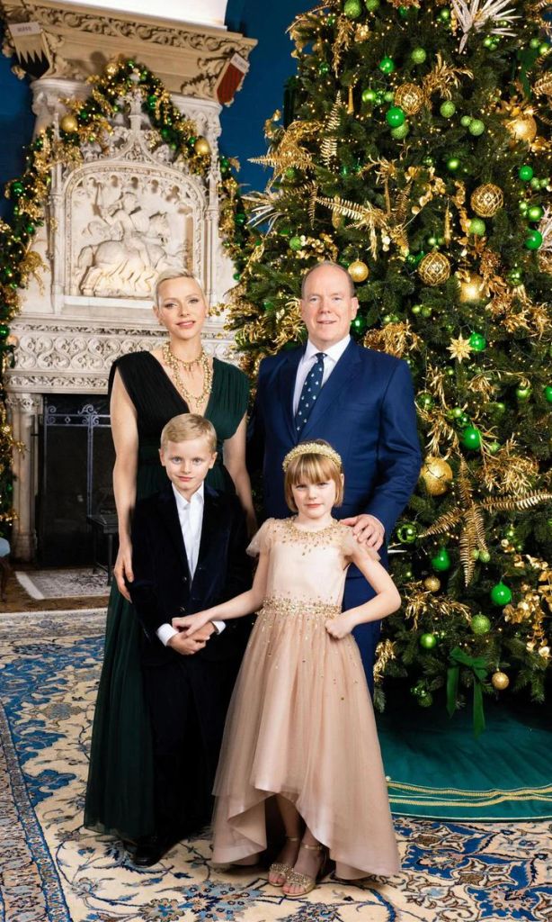 princess charlene, prince albert, prince jacques, and princess gabriella pose under christmas tree in palace