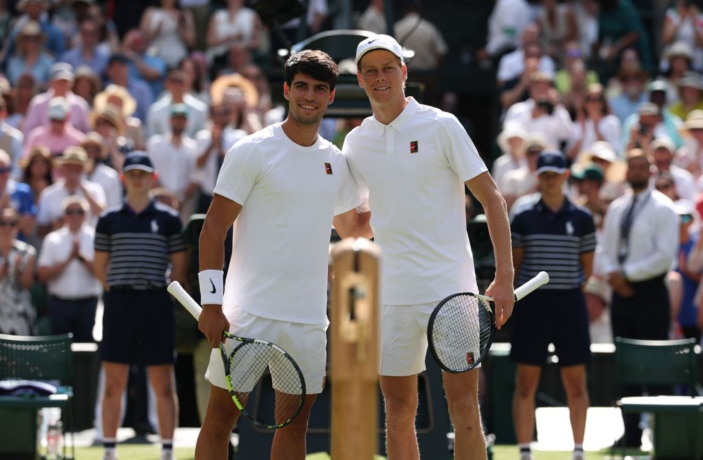 Carlos Alcaraz of Spain and Jannik Sinner of Italy pose for a photo at the net prior to the Gentleman's Singles Final on day fourteen of The Championships Wimbledon 2025 at All England Lawn Tennis and Croquet Club on July 13, 2025
