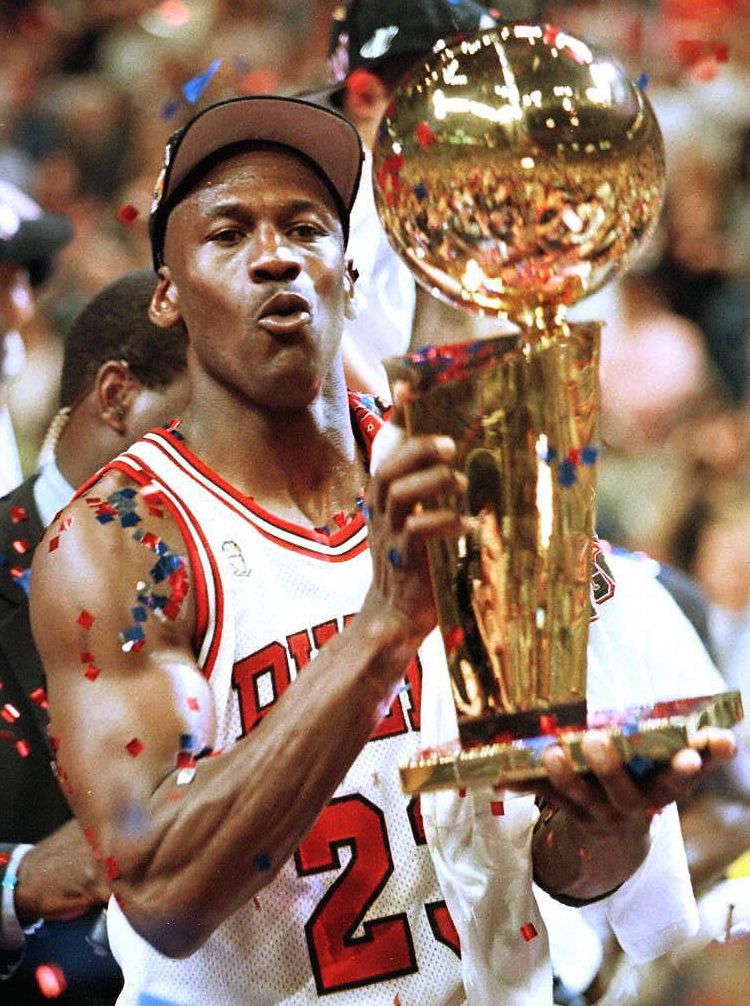 Michael Jordan of the Chicago Bulls holds the Larry O'Brien Trophy after the 1997 NBA Finals