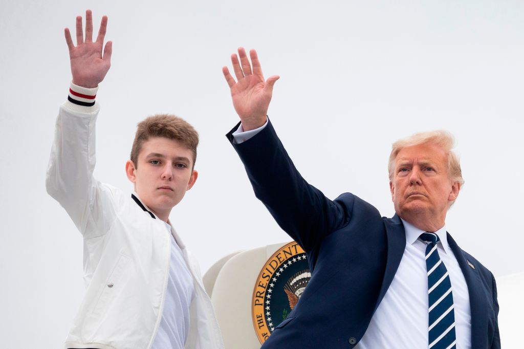 Donald Trump and his son Barron wave as they board Air Force One