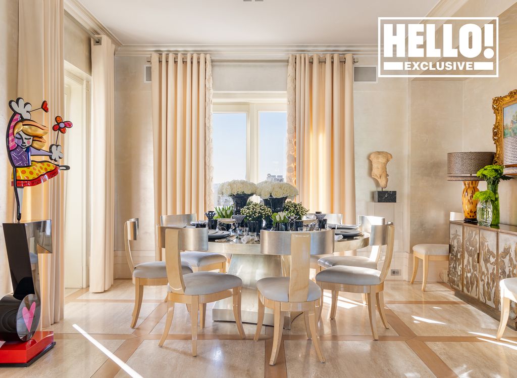 Celia Kritharioti dining room with cream curtains and circular table and modern art