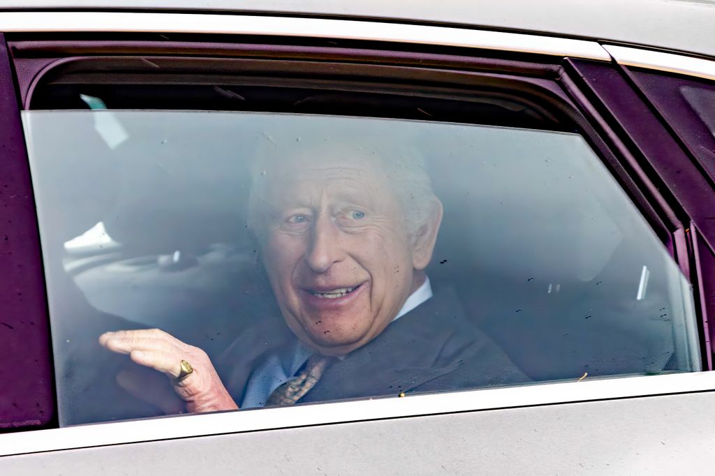 king charles waving in back of car