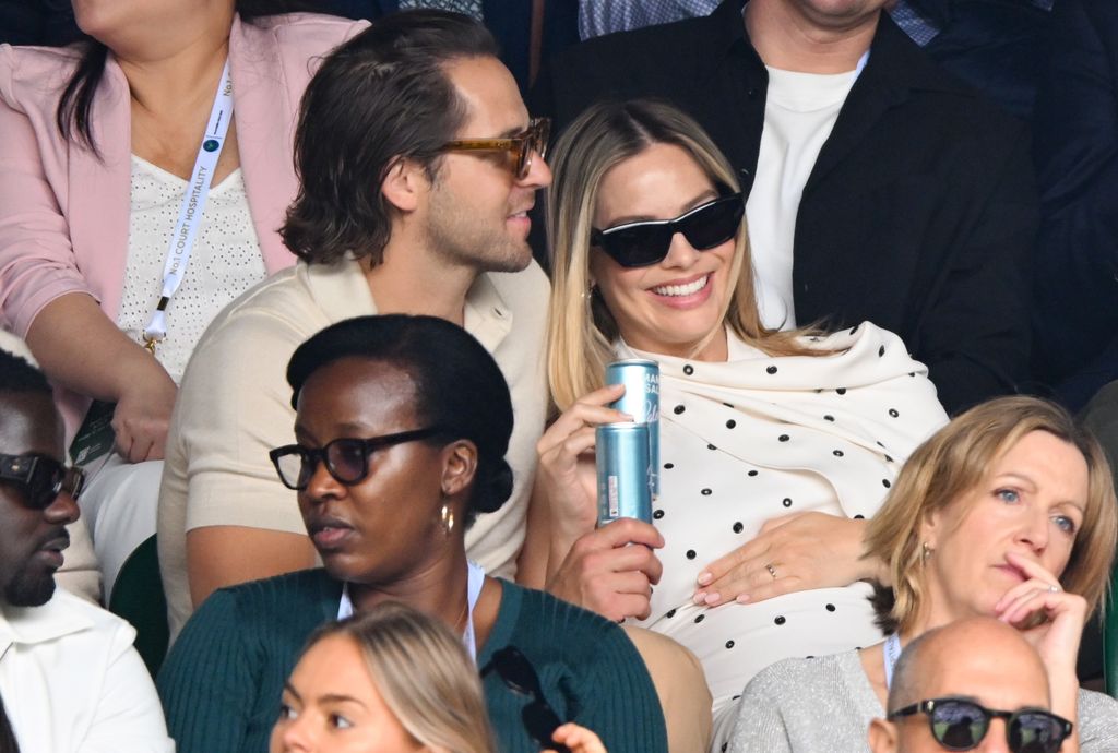 Tom Ackerley and Margot Robbie court-side of Centre Court on day twelve of the Wimbledon Tennis Championships at the All England Lawn Tennis and Croquet Club on July 12, 2024 in London, England.