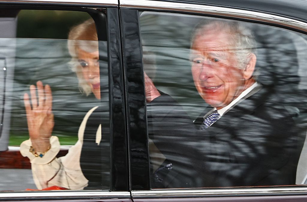 King Charles III and Queen Camilla wave as they leave by car from Clarence House in London 