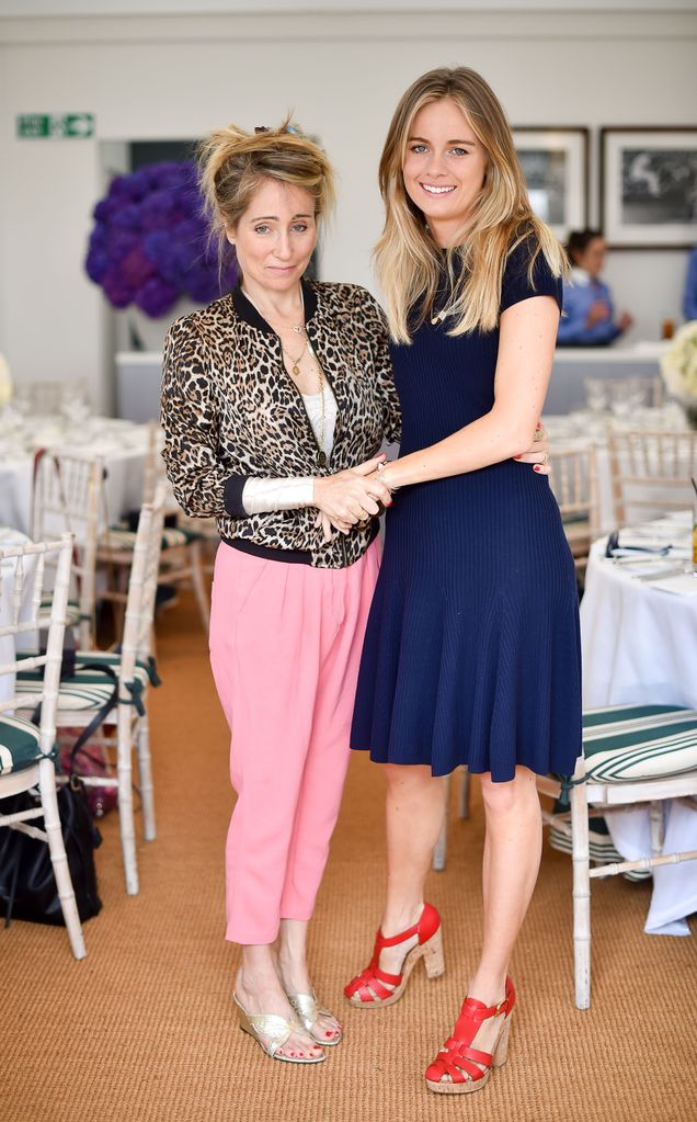 Two women holding hands in colourful clothing