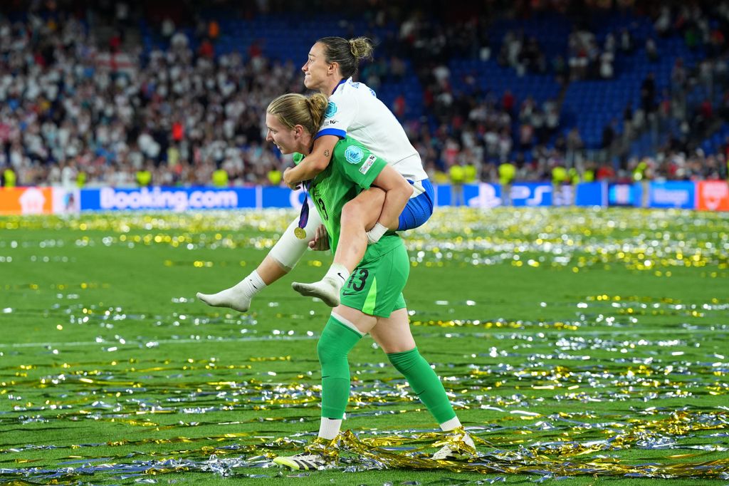 Anna Moorhouse of England carries Lucy Bronze as they celebrate victory after England defeat Spain during the UEFA Women's EURO 2025 Final match between England and Spain at St. Jakob-Park on July 27, 2025 in Basel, Switzerland.
