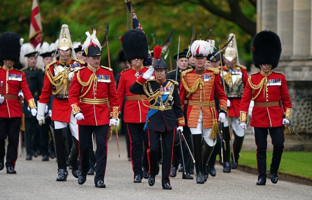 Princess Anne in the gardens of Buckingham Palace during a royal salute from members of the military
