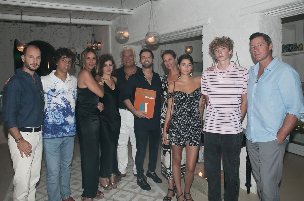 ATHENS, GREECE  AUGUST 1: In this handout image provided by Panas Group, (L-R) Leo Vrondissis, Constantine Georgiopoulos, Kara Young, Alkistis Poulopoulou, Peter Georgiopoulos, Chrysanthos Panas, Christy Turlington, Grace Burns, Finn Burns and Edward Burns attend as Christy Turlington dines in Island restaurant and is gifted the Athens Riviera & Greek Islands book by Chrysanthos Panas on August 1, 2022 in Athens, Greece. (Photo by Panas Group via Getty Images)
