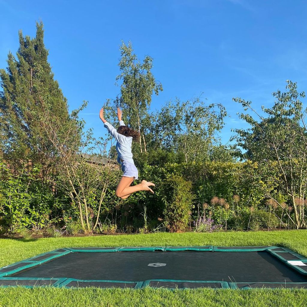 photo of Emma and Matt Willis' daughter jumping on trampoline in their garden