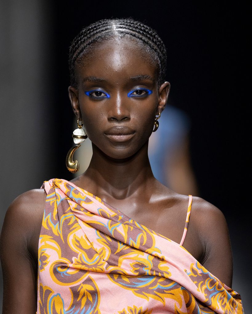 Model walks the Etro runway with striking blue eye make-up