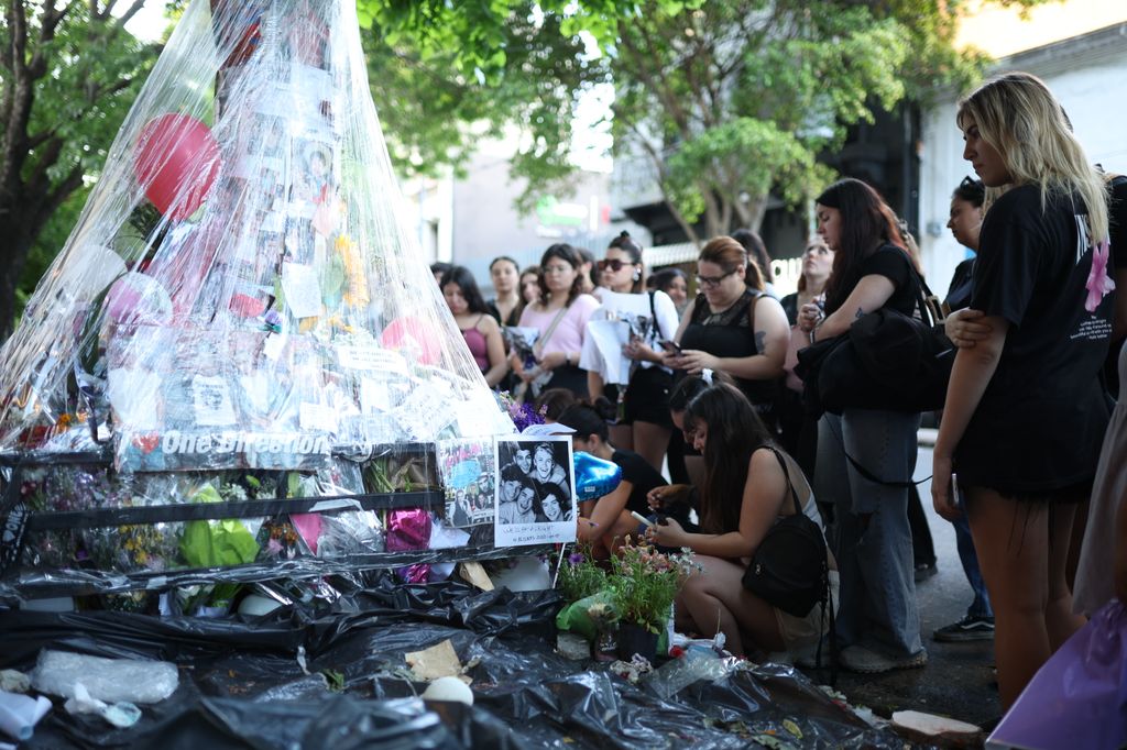 Fans visit the memorial altar for singer Liam Payne outside Casa Sur Hotel on October 21, 2024 in Buenos Aires, Argentina. According to the Buenos Aires police department, Payne fell from a third-floor hotel room balcony in Palermo, a famous neighborhood in Buenos Aires. Fans around the city gather to pay tribute to the former member of boy band One Direction.