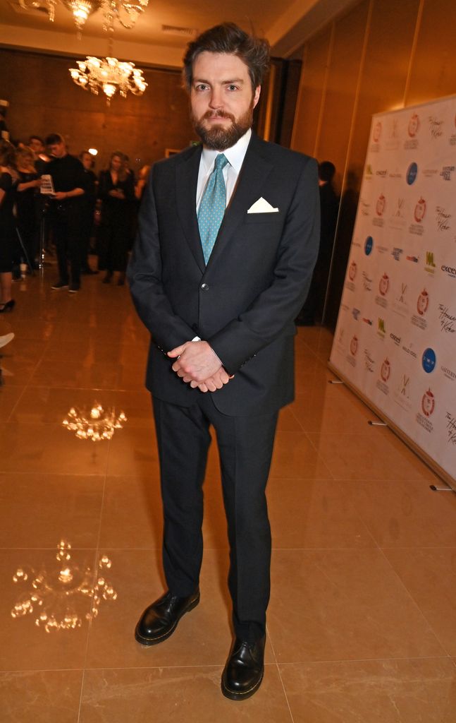 Cormoran Strike actor Tom Burke wearing a suit