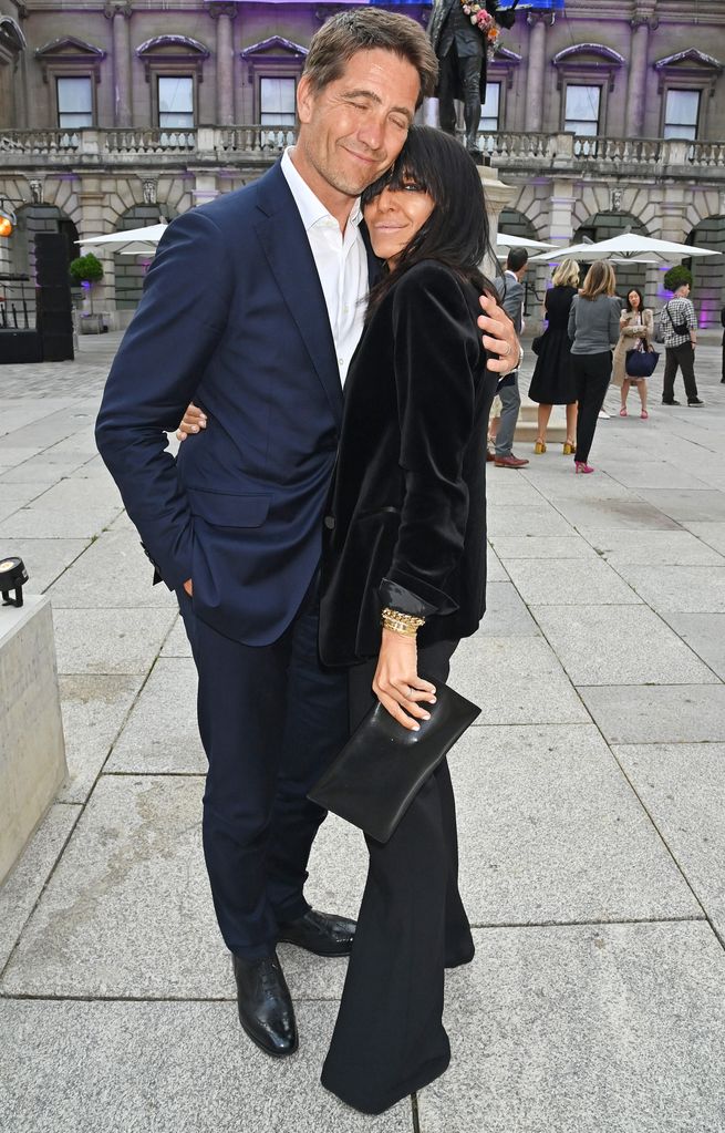 Kris Thykier and Claudia Winkleman hug in London wearing suits