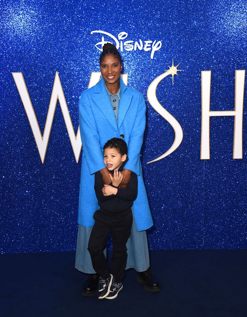 Denise Lewis in blue holding her young son