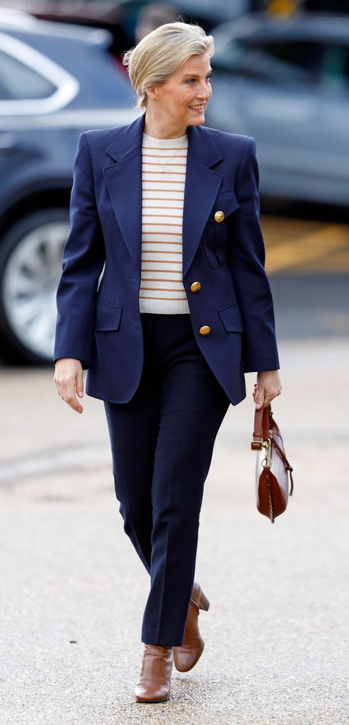 The Duchess of Edinburgh walking in striped top and navy suit