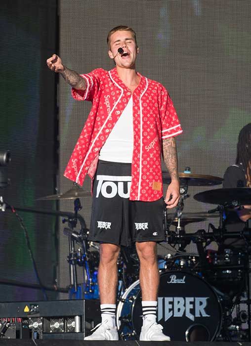 Justin Bieber on a stage belting out a song
