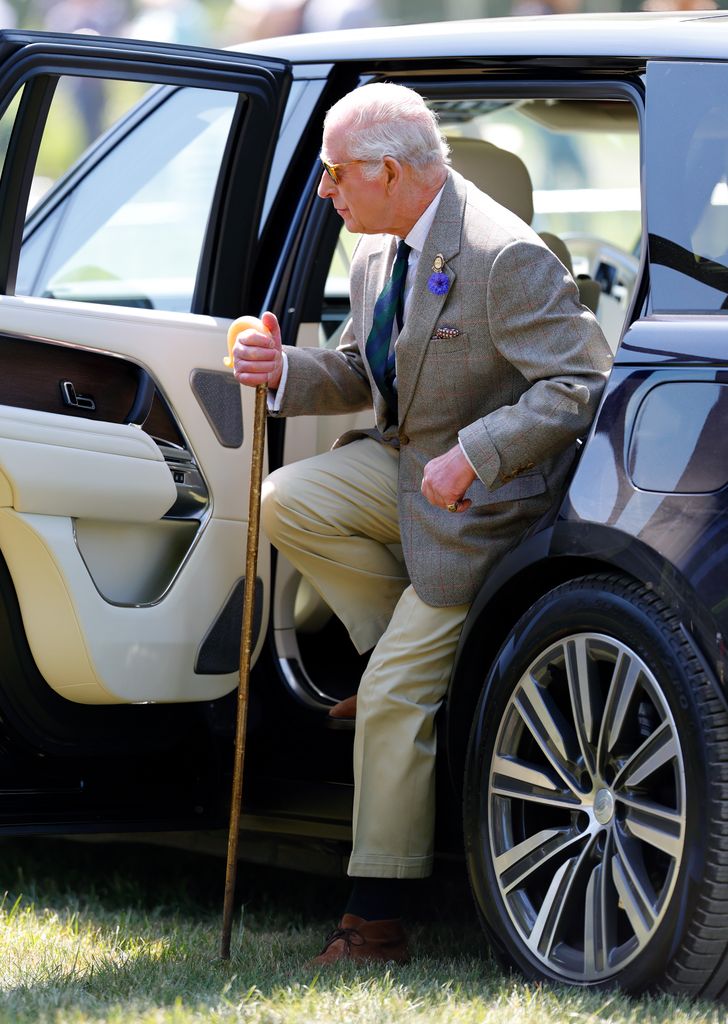 King Charles getting out of the car at the 2025 windsor horse trials with a walking stick