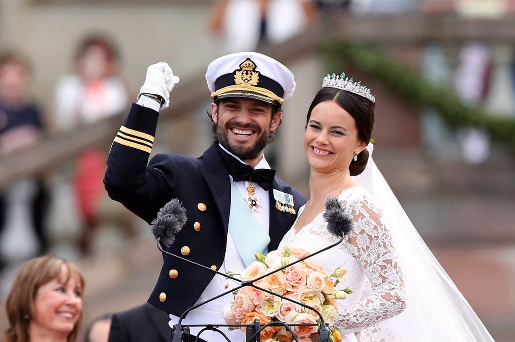  Prince Carl Philip of Sweden and his wife Princess Sofia of Sweden salute the crowd after their marriage ceremony on June 13, 2015 