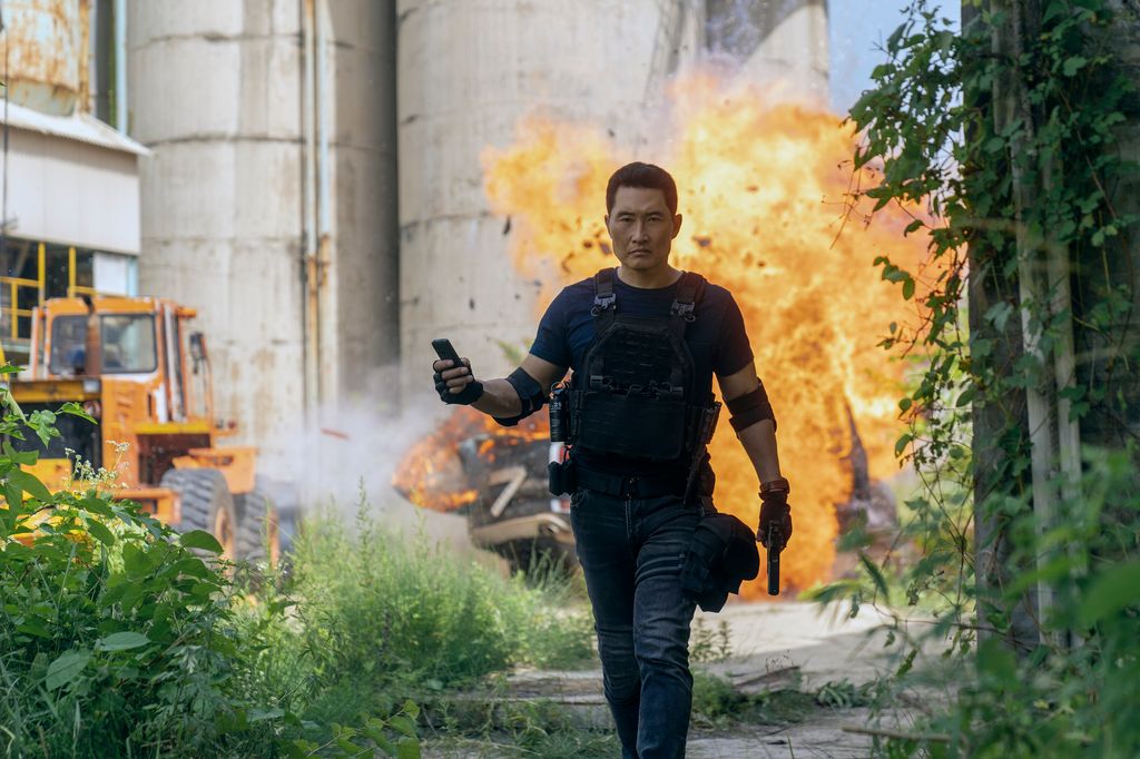 man walking away from explosion