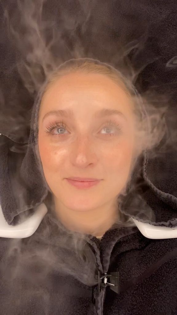 Woman having hair steam treatment