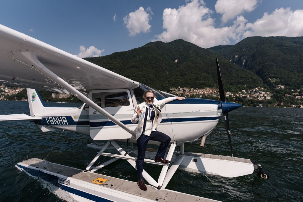 Groom standing on a seaplane in Lake Como