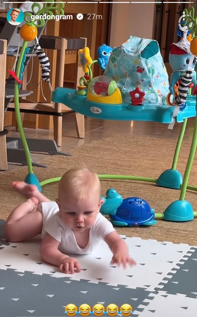 baby crawling on mat 