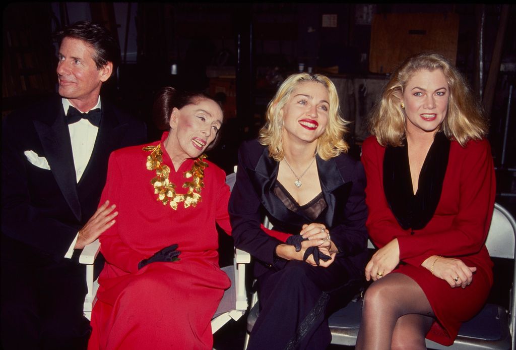 American fashion designer Calvin Klein, dancer & choreographer Martha Graham (1894 - 1991), singer & actress Madonna, and actress Kathleen Turner holding hands 