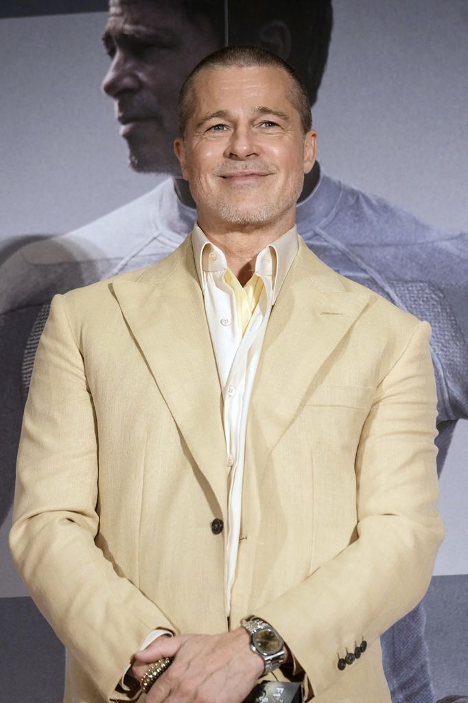This photo taken on June 25, 2025 shows US actor Brad Pitt smiling on stage as he attends an event for his latest film "F1: The Movie", in Tokyo. (Photo by JIJI Press / AFP) / Japan OUT (Photo by STR/JIJI Press/AFP via Getty Images)