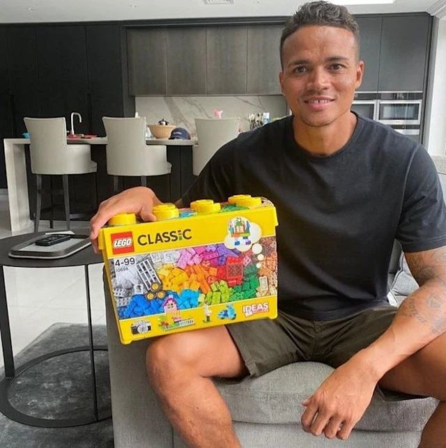 jermaine jenas smiling with lego box in modern kitchen