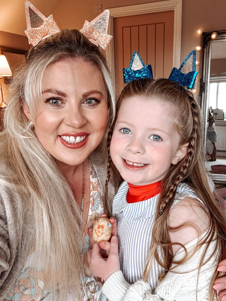 Mother and daughter selfie wearing party headbands 