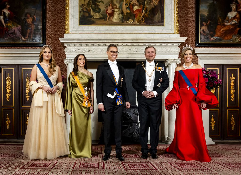 King Willem-Alexander, Queen Maxima and Princess Amalia pose with Finland's president Alexander Stubb, and his wife, Suzanne Innes-Stubb, during an official photo at the Roya Palace in Amsterdam on the first day of Stubb's two-day state visit to the Netherlands. 